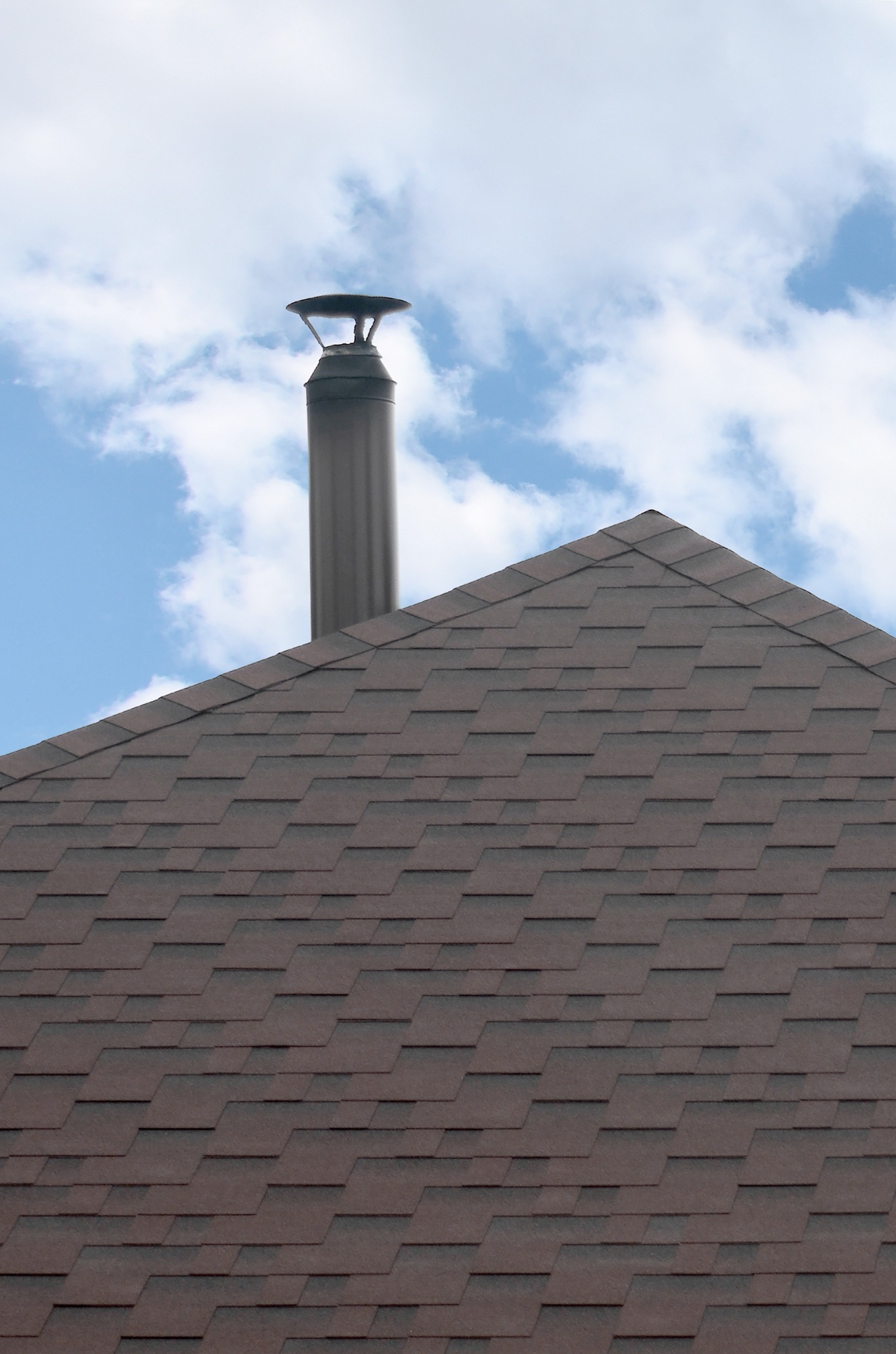 The roof covered with a modern flat bituminous waterproof coating under a blue sky