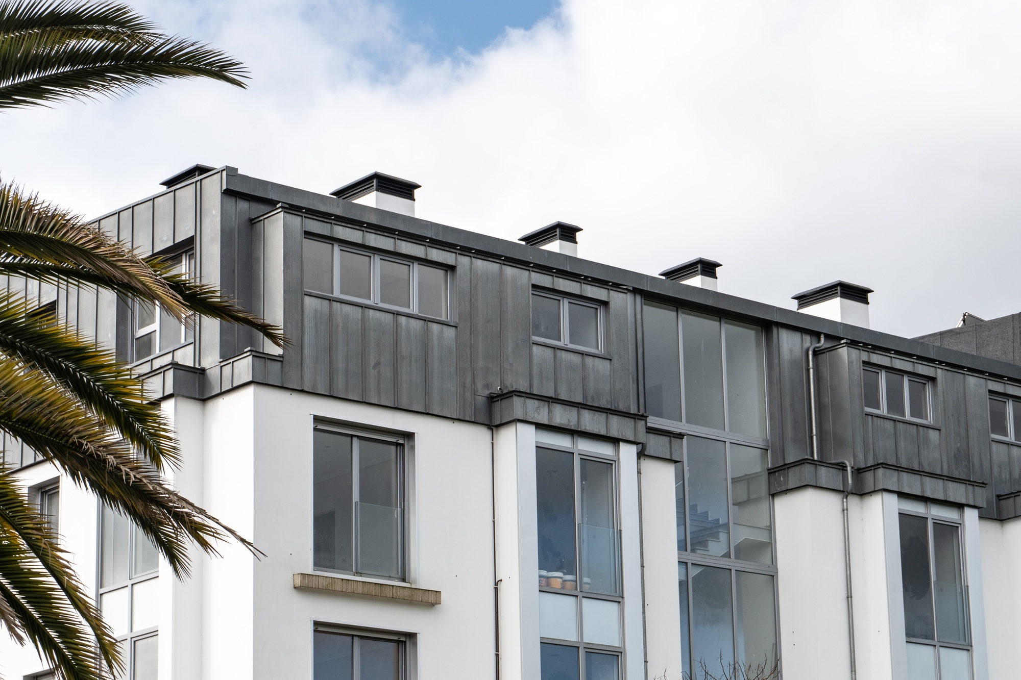 Modern building with gray zinc roof